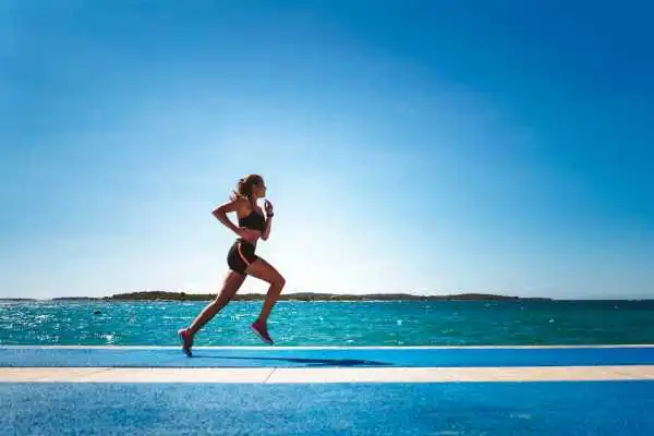 Woman running showing strong leg muscle West Drayton